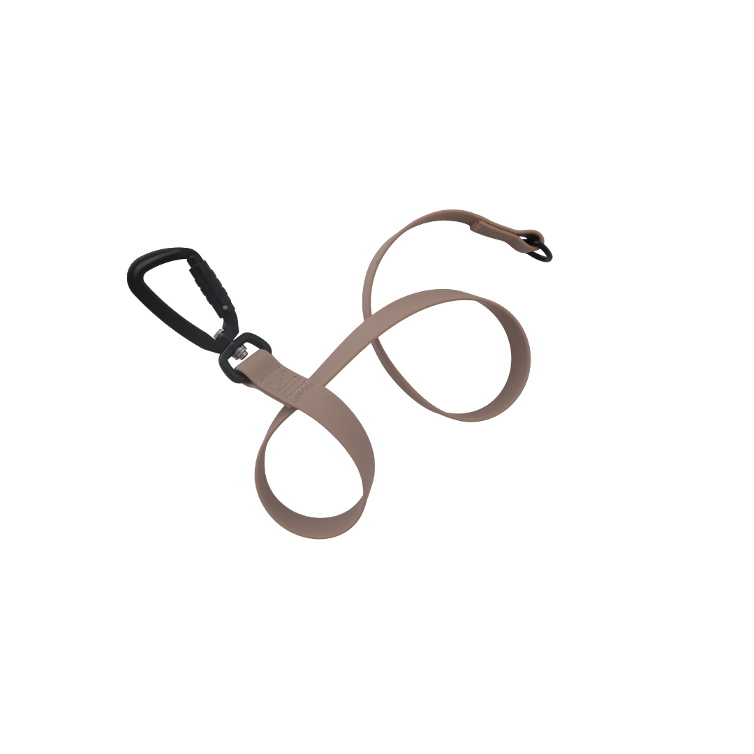 A sleek beige dog leash with a black metal carabiner clasp lays coiled against a black background.