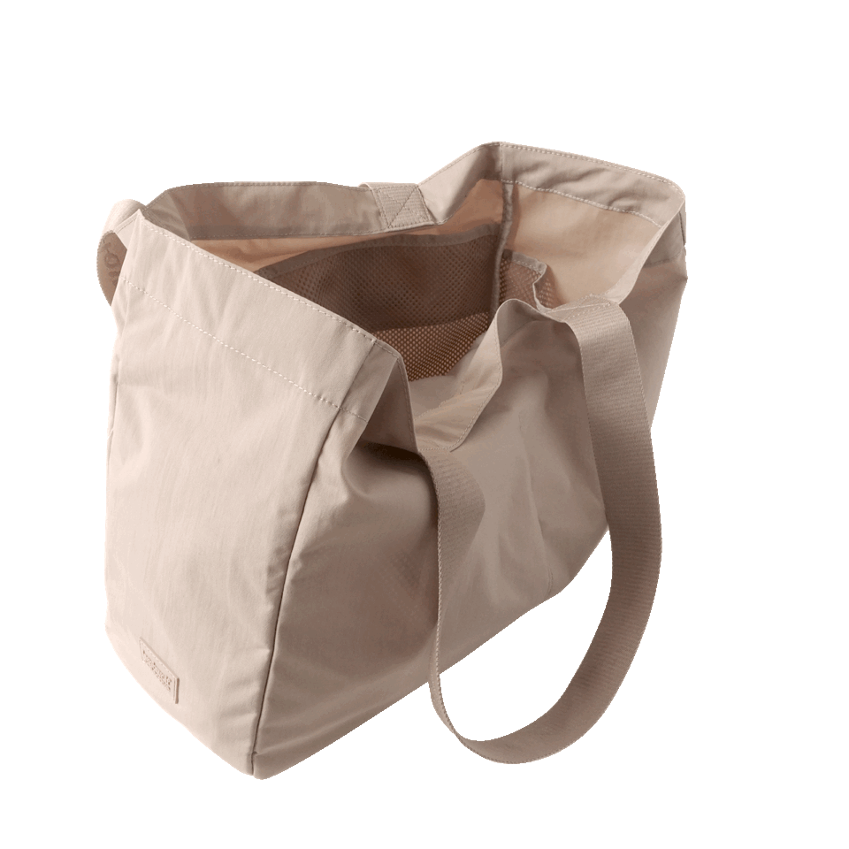 Open beige tote bag with internal mesh pocket and long shoulder straps.