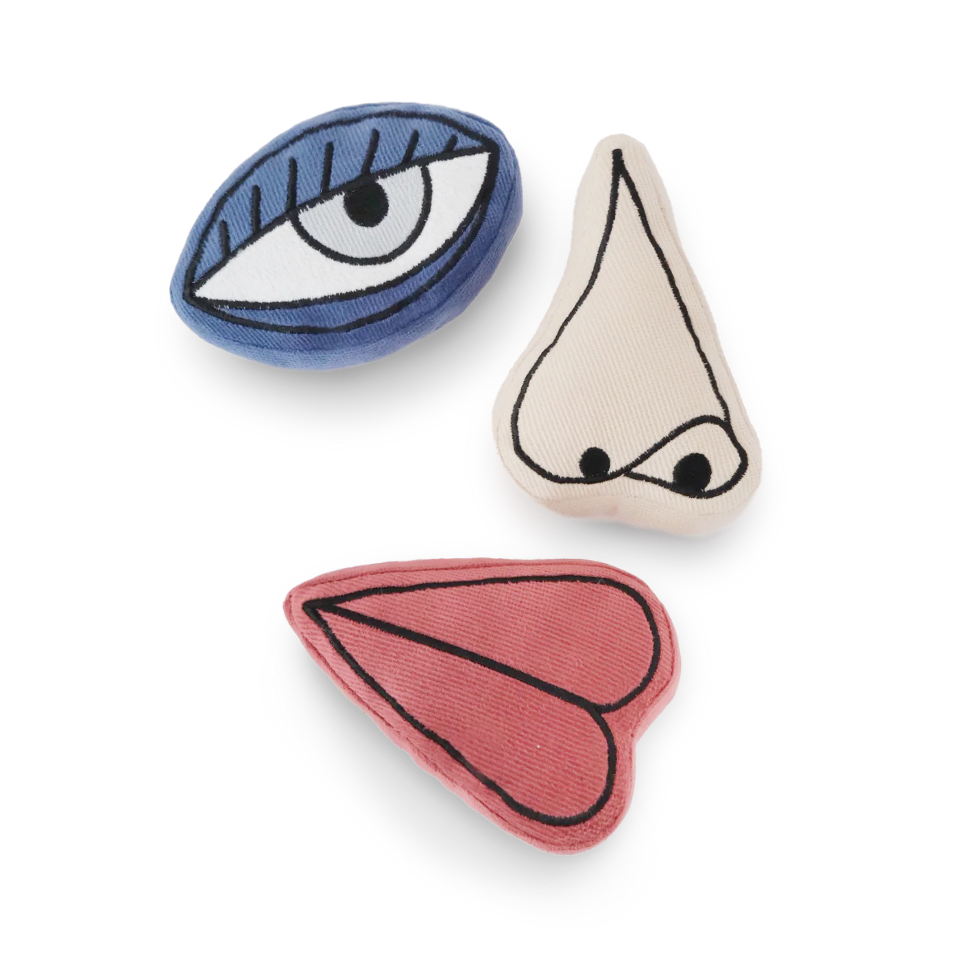 Three decorative items shaped like an eye, nose, and mouth on a white background