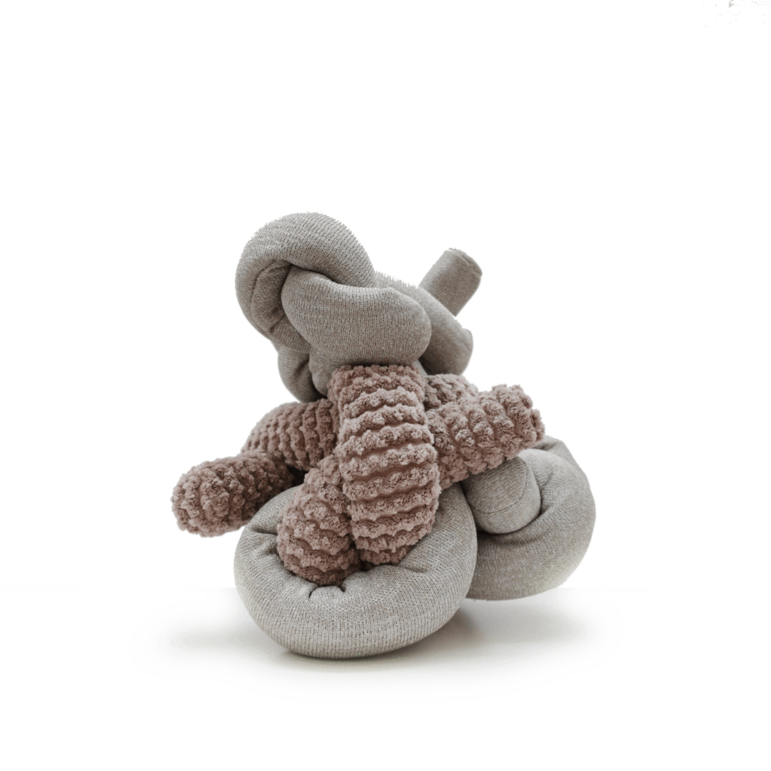 Handmade sock creature with knotted gray body and textured mauve arms sitting on a white surface. 
